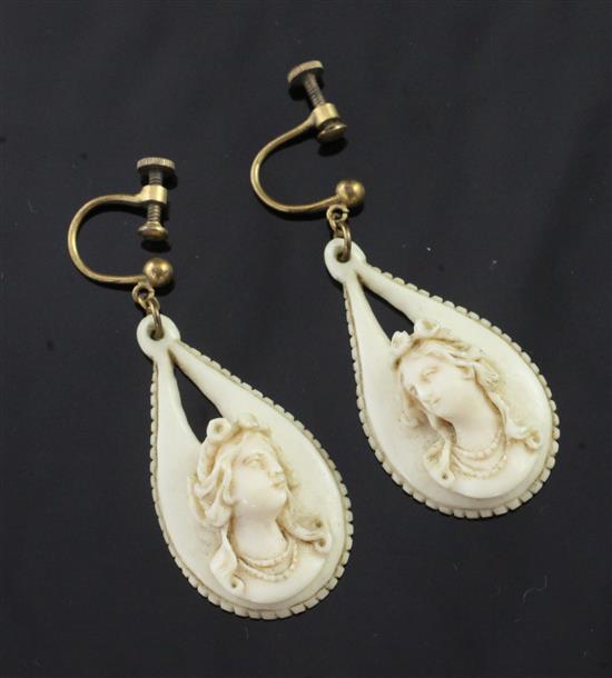 A pair of early 20th century teardrop shaped ivory earrings, 34mm.